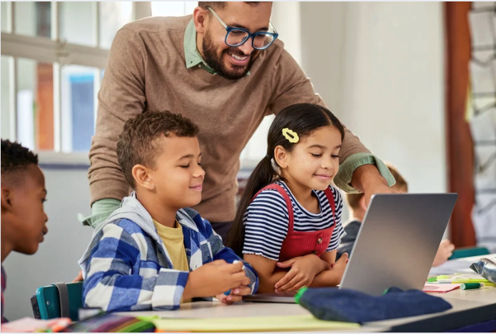 students using a laptop in a classroom