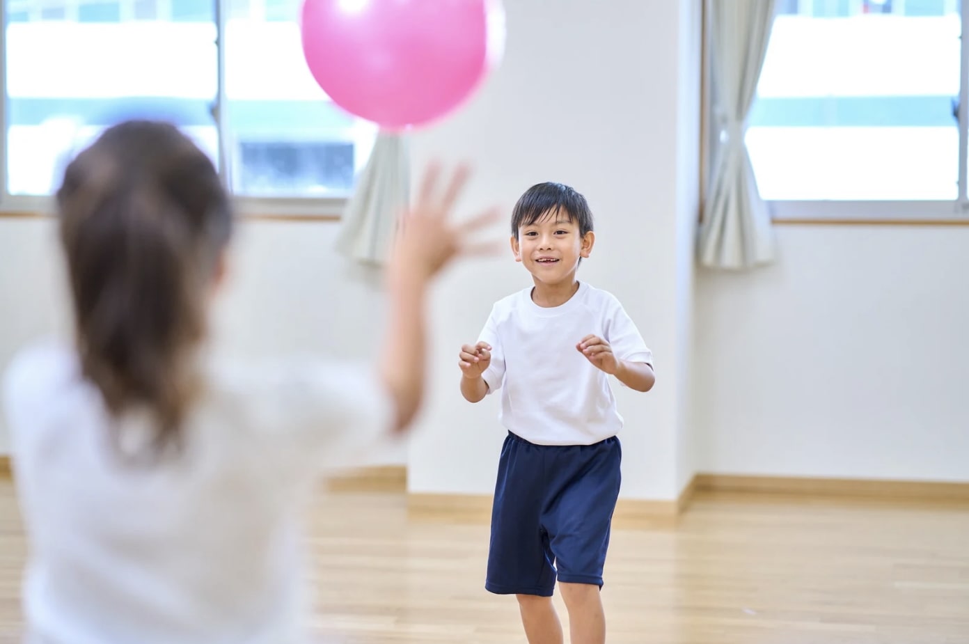 kid catching balloon