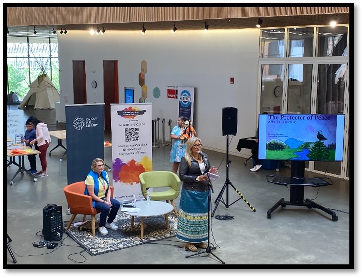 Cindy Martin, the great-great-great niece of Hall of Famer Tom Longboat reads to youth at a National Indigenous History Month event in 2024.