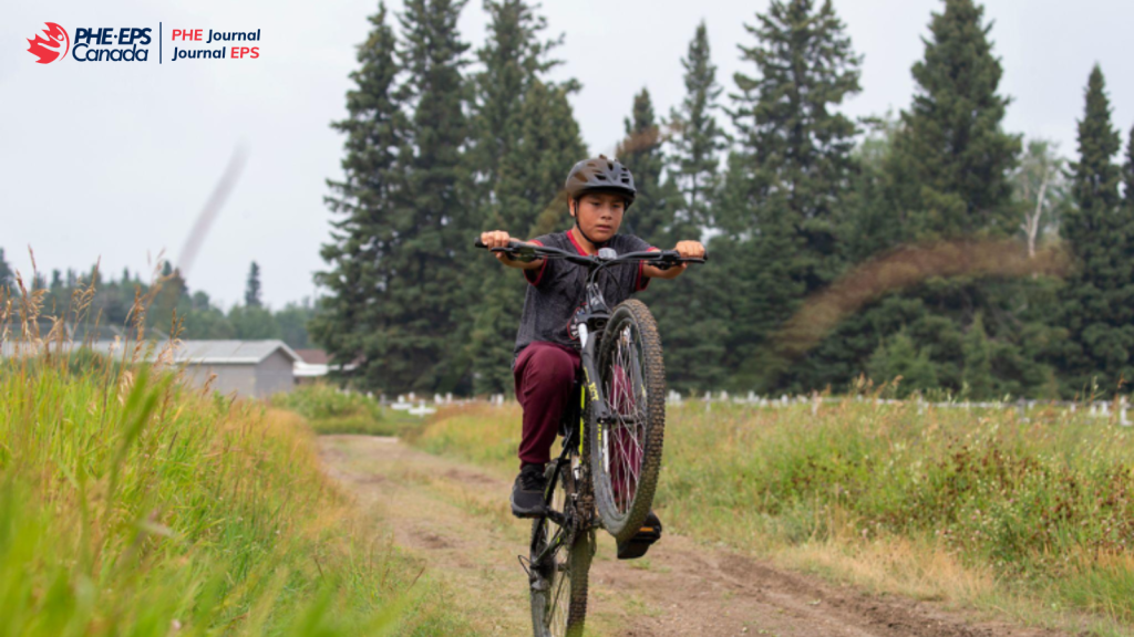 The photo shows a kid wearing a helmet on a bike attempting tricks.