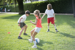 Children playing soccer outdoors 