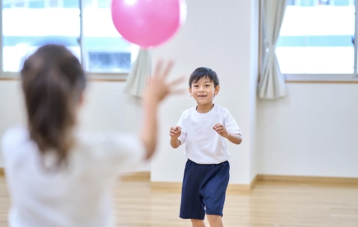 child catching a balloon