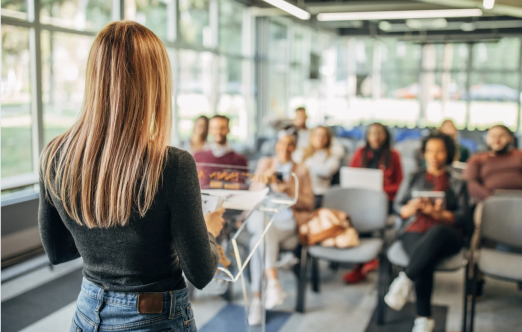 woman presenting to a small crowd